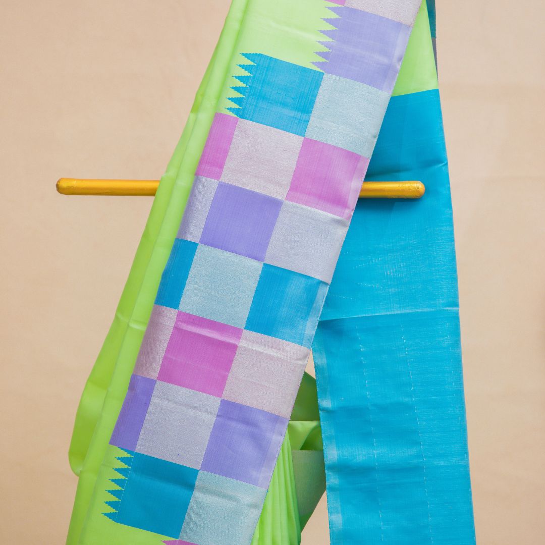 pista green -plain body with checked border & blue colour pallu with unstitched blouse