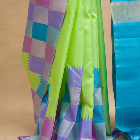 Pista green plain body with checked border and blue colour pallu with unstitched blouse